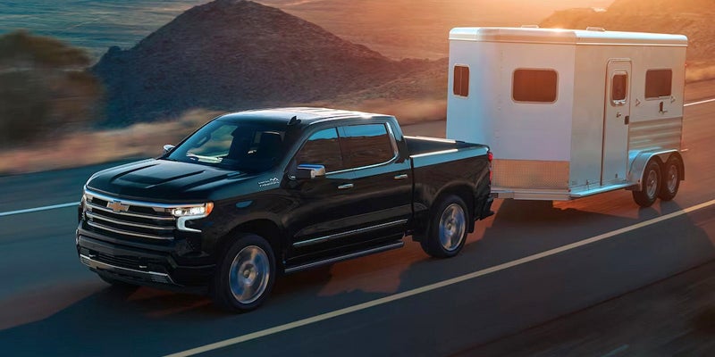 2024 Chevrolet Silverado towing a camper	